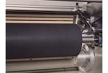 Close-up of a cylindrical roller coated in conductive ceramic (ST42) on a corona treater.