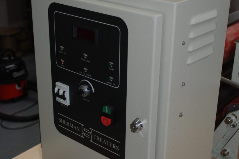 GX20 corona generator control panel with buttons and a digital display, housed in a beige cabinet.