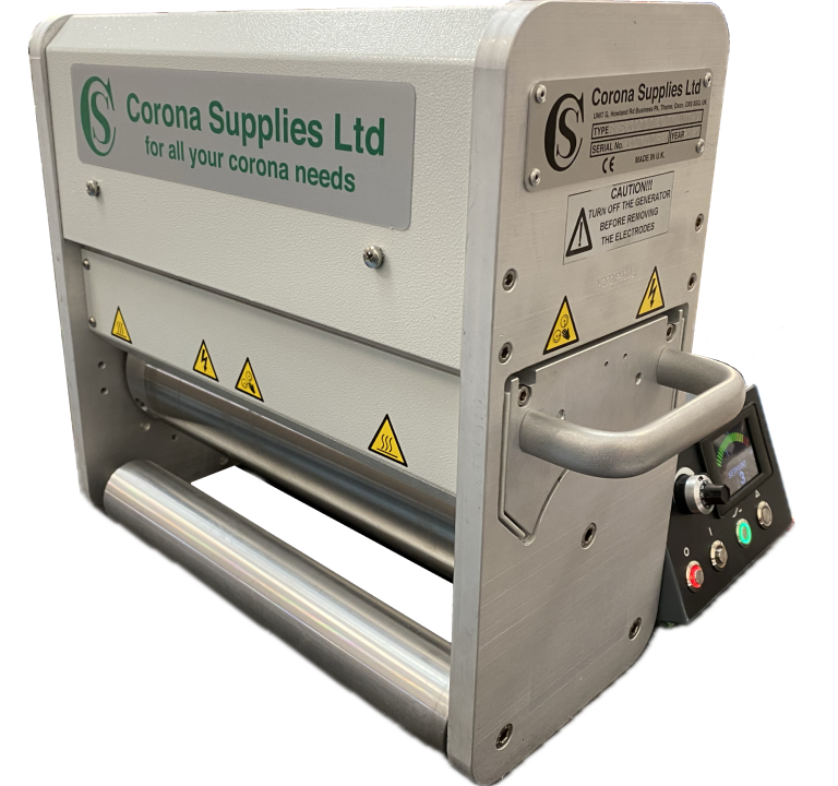 Narrow web corona treater with safety warnings and control panel.