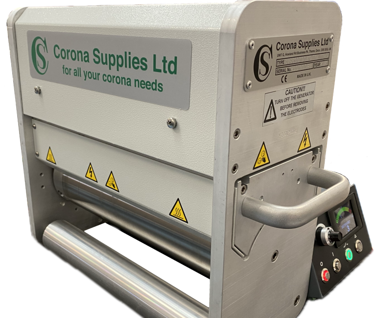 Narrow web corona treater with safety warnings and control panel.