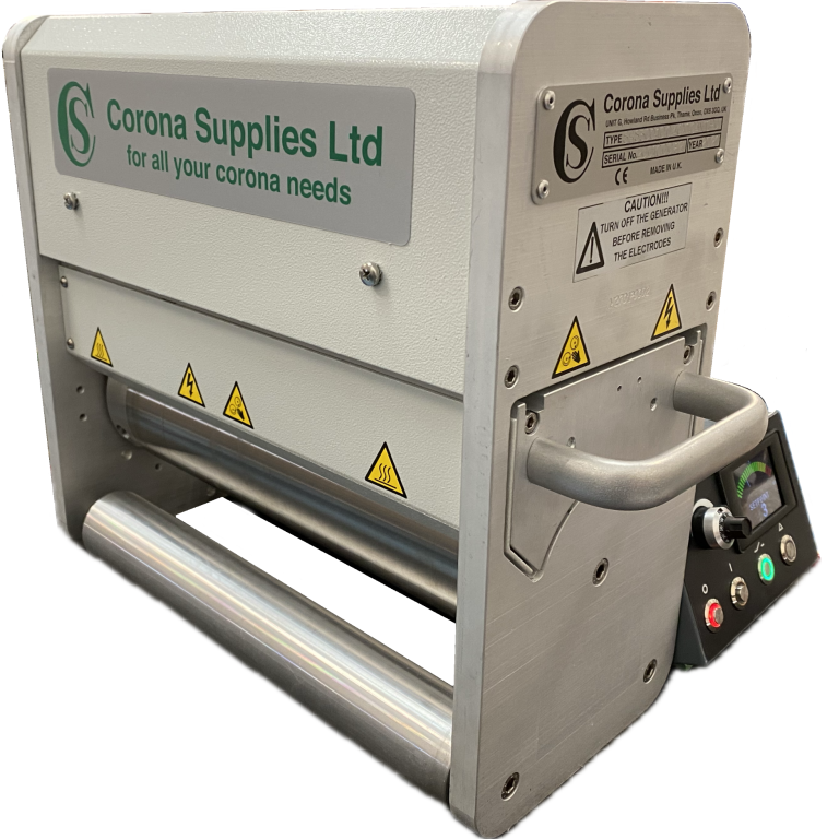 Narrow web corona treater with safety warnings and control panel.