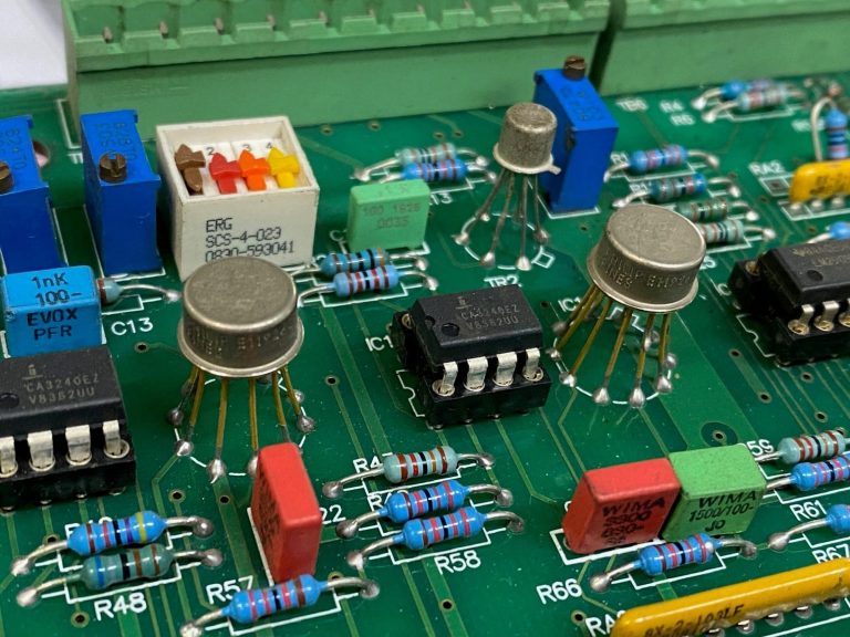 Close-up of a circuit board with various electronic components and colour-coded resistors.